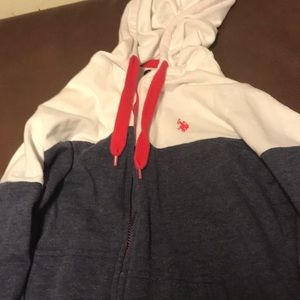 A white and navy polo sweater